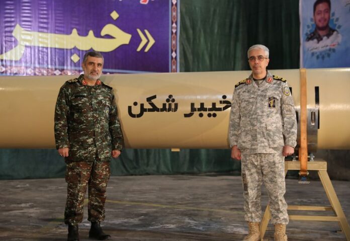 Iranian Armed Forces Chief of Staff Major General Mohammad Bagheri and IRGC Aerospace Force Commander Amir Ali Hajizadeh stand together during the unveiling of