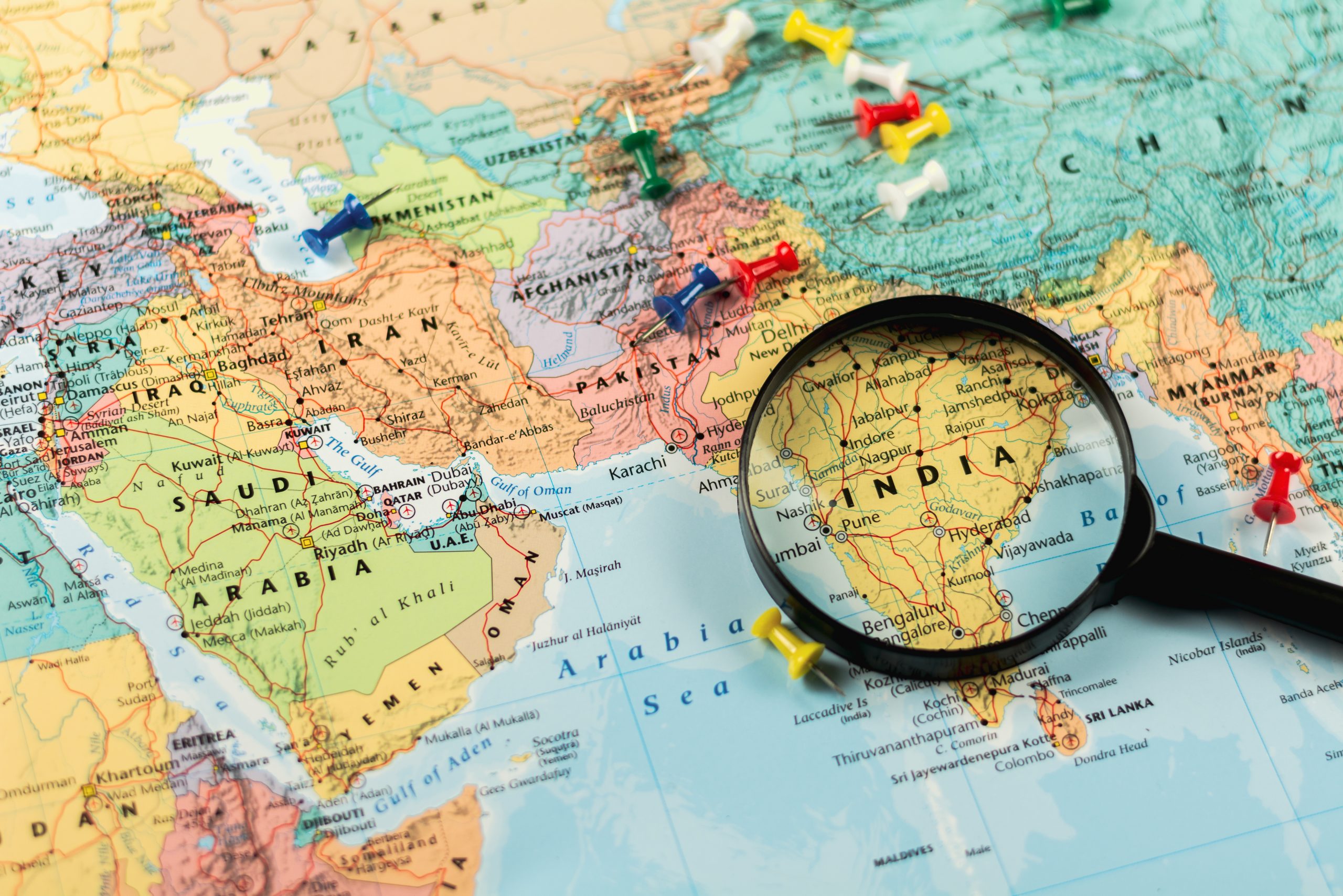 magnifying-glass-world-map-selective-focus-india-economic-business-concept-scaled
